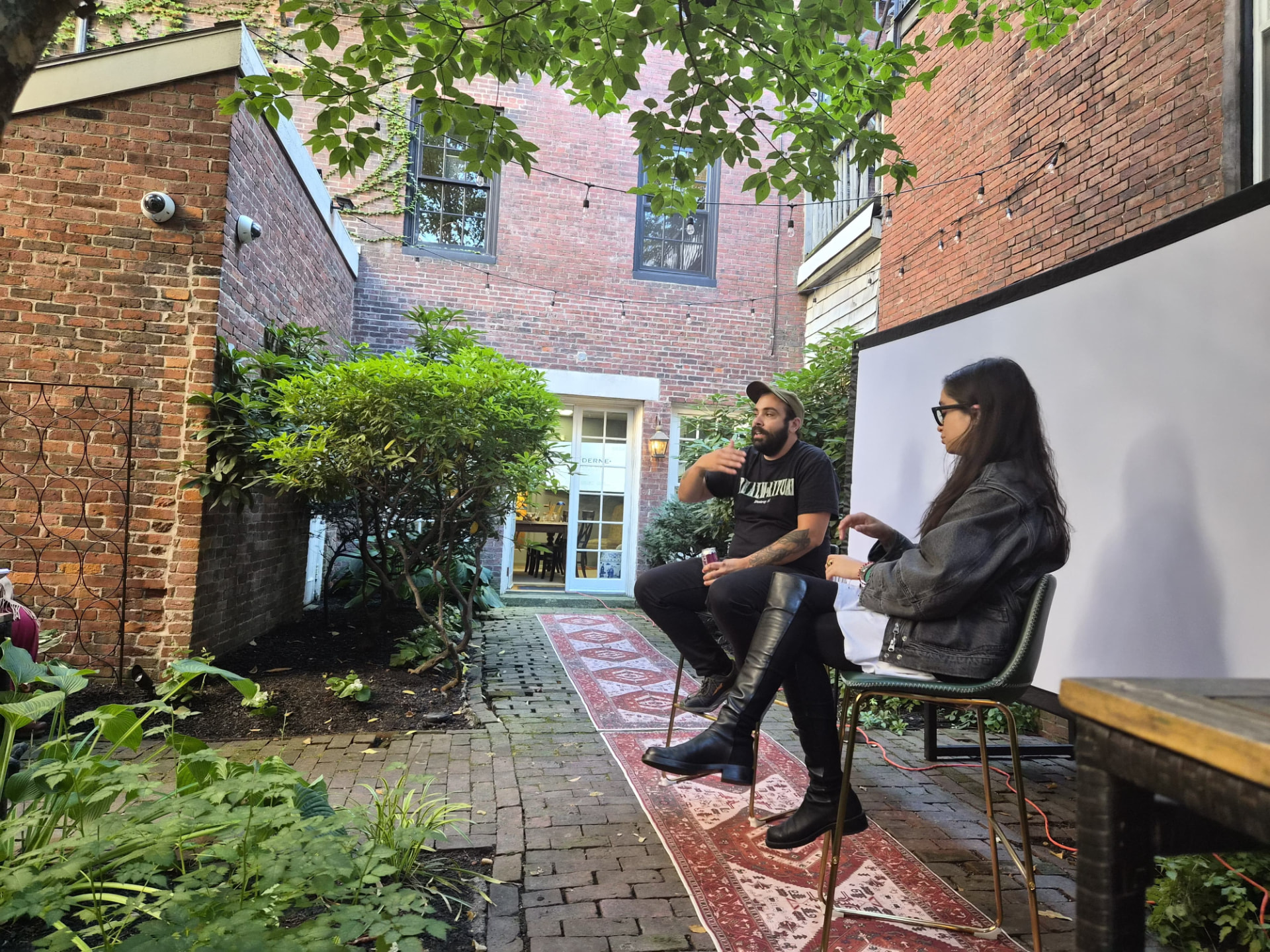 Discussion beside the screen at the inaugural Joker salon